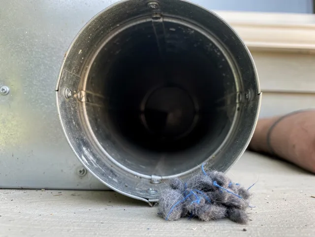 Stonington Dryer Vent Cleaning technician using specialized equipment to clear severe dryer vent blockage in Stonington